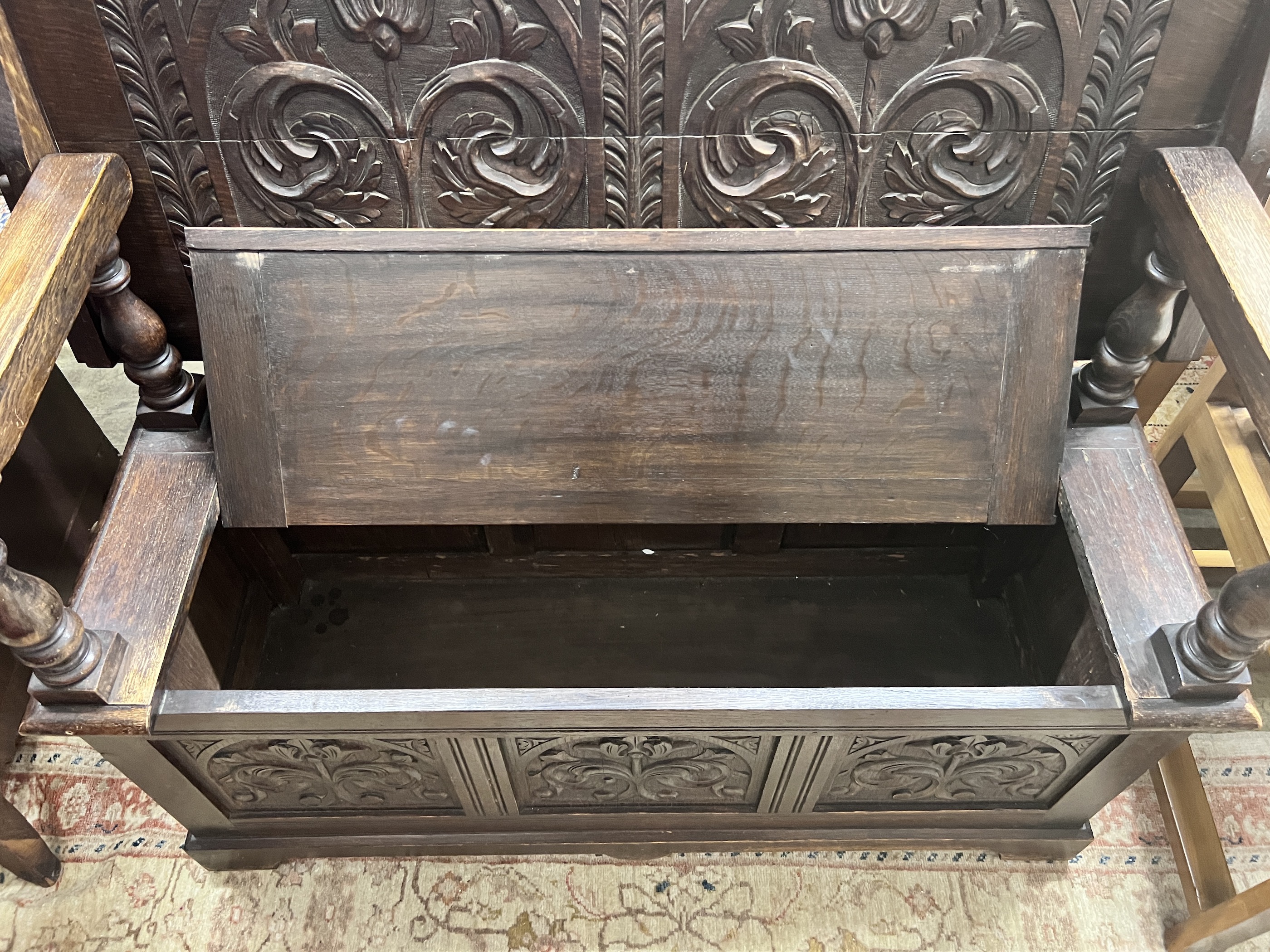 A 1920’s carved oak monk's bench, width 122cm, depth 51cm, height 78cm